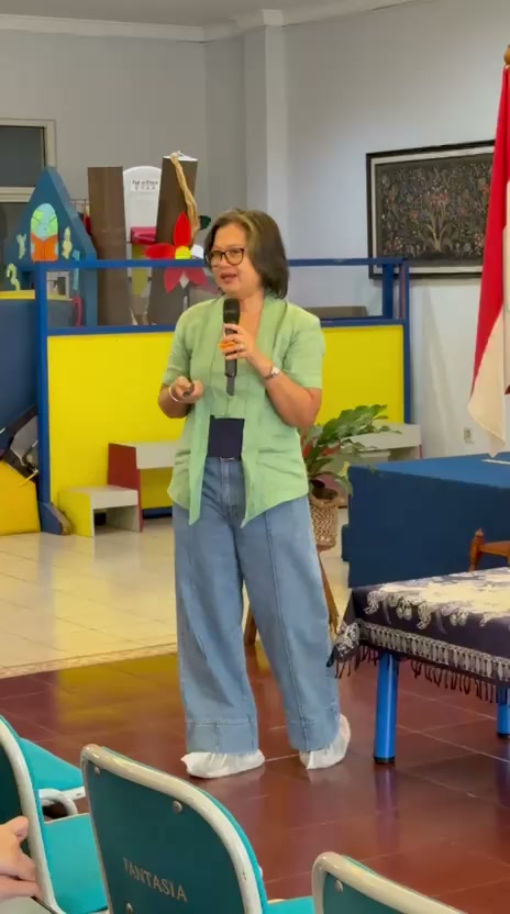 Dr Santi speaking with a microphone